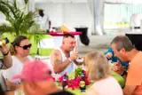 Foodie tour guests taste dishes together at a flower-decorated terrace table.