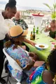 A team member serves a small plate to a guest seated on Carambola’s terrace.