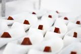 Small white bowls with bite-size brown sweets arranged for the Carambola food tour.