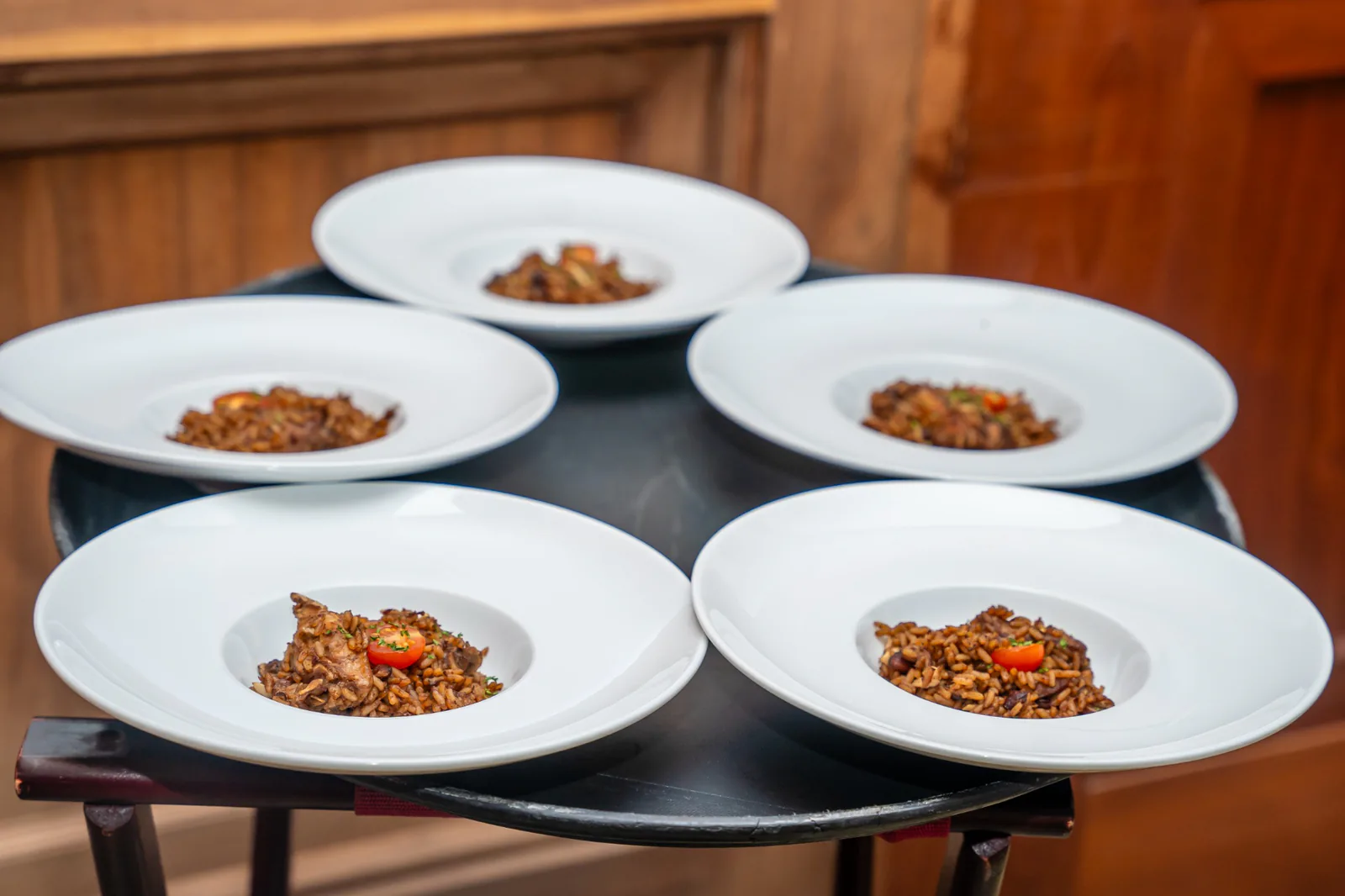 Five white bowls of rice dishes arranged for guests on the Carambola food tour.