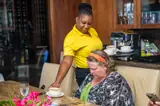 A Carambola team member attends to a seated guest during the food tour.