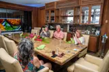 Guests enjoy small plates together in Carambola Beach Club’s wood-panelled dining room.